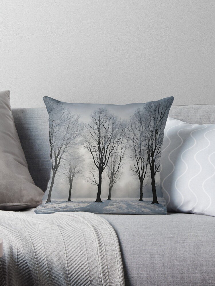 Snowy Trees with the Sun Shining Through Throw Pillow on the couch